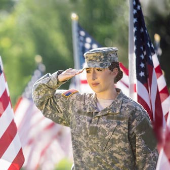 Female soldier saluting American flag