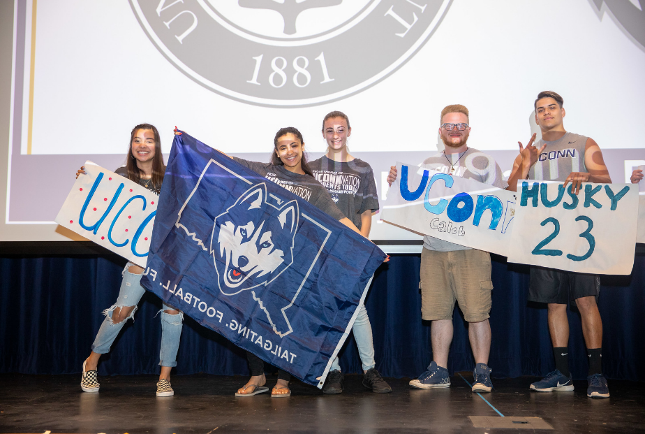 Students holding UConn banners
