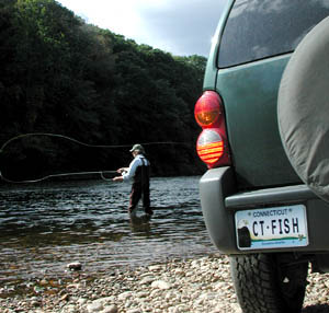 Flyfisherman near vehicle with simulated Wildlife License Plate.