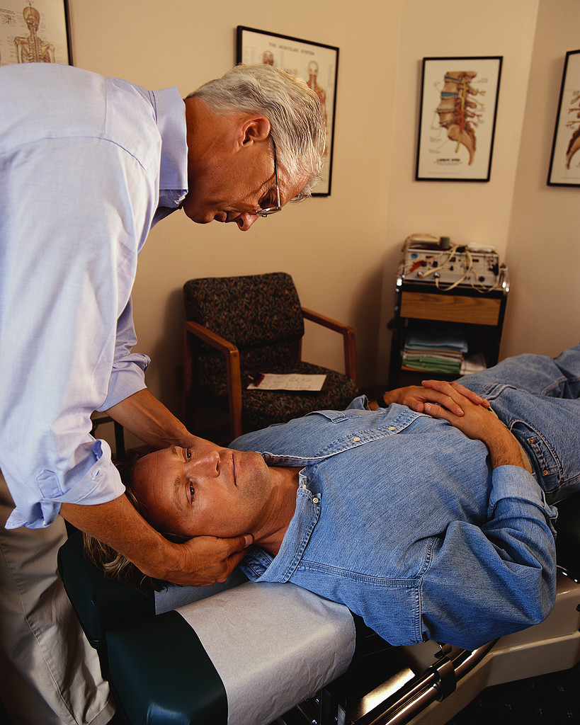 Doctor of Chiropractic with patient