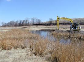 Equipment excavating ponds and channels