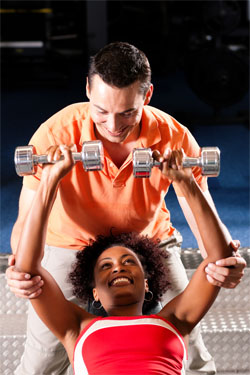 trainer and woman exercising