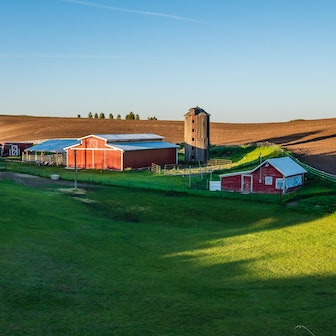 Farmland with barns in the background