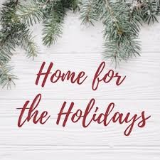 The text "Home for the Holidays" appears in a red cursive font over a pale wood background with some evergreen branches on top