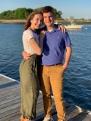 Photo of Maddy and Owen Allen hugging by the water