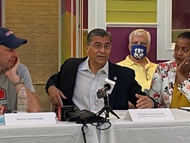 HHS Secretary Xavier Becerra speaking with other leaders in Connecticut