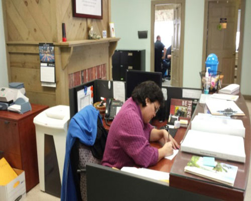 Abby Snyder sitting at a desk at work