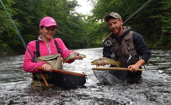 Friends catching brown trout together on the Farmington River