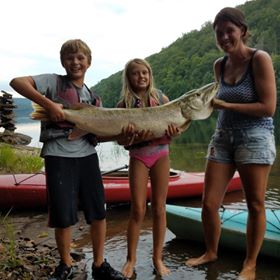 woman and family holding record pike