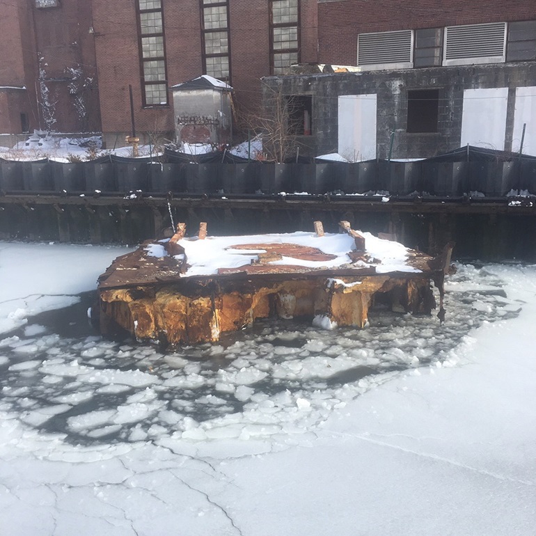 Abandoned barge tied to English Station Power Plant on Mill River