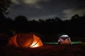 Two tents under starry night sky