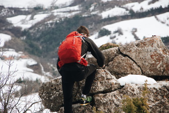 Man climbing rocks in winter