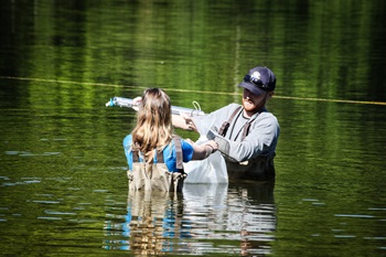 DEEP staff collect a water quality sample at a state swimming area