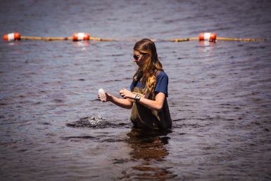 DEEP staff collect a water sample from a State beach.