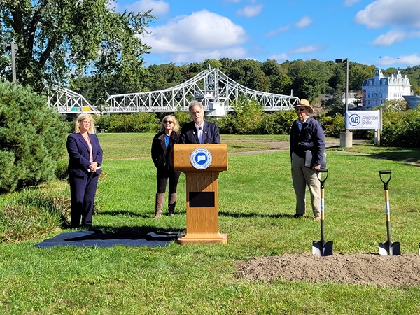 CTDOT Commissioner Giulietti stands at podium with Swing Bridge in the background. Behind him left to right is East Haddam First Selectman Irene Haines, State Rep Christine Palm and Haddam First Selectman Bob McGarry
