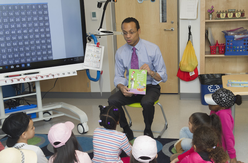 Treasurer Shawn T. Wooden reading to a classroom.