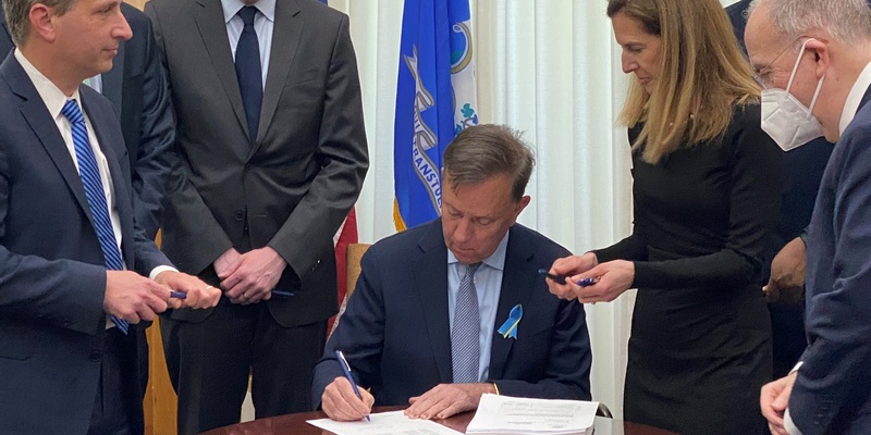 Governor Lamont signing the fiscal year 2023 budget adjustment bill