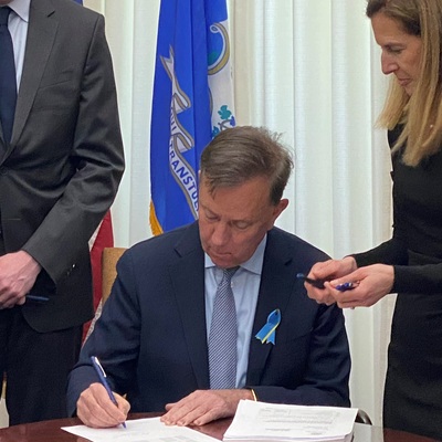 Governor Lamont signing the fiscal year 2023 budget adjustment bill