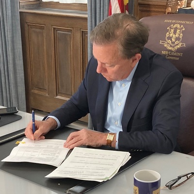 Governor Ned Lamont signs the gas tax holiday into law