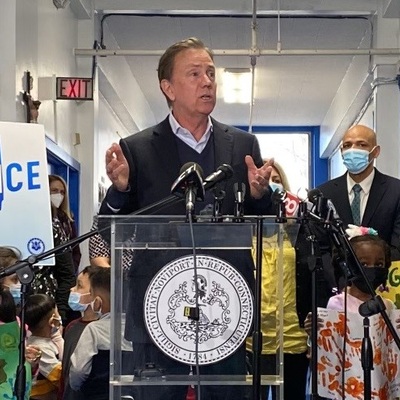 Governor Lamont speaking in the hallway of an elementary school