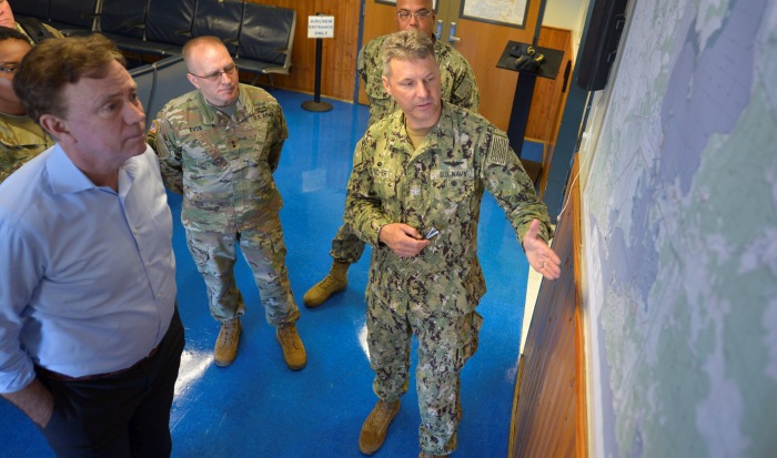 GUANTANAMO BAY, Cuba (Dec. 27, 2019) Capt. John Fisher, commanding officer of Naval Station Guantanamo Bay (NSGB), right, briefs Governor Ned Lamont, left, and Maj. Gen. Francis Evon, Jr., adjutant general of the Connecticut National Guard, center, about the location of NSGB in the U.S. Southern Command area of operations. NSGB is the forward, ready, and irreplaceable sea power platform in the Caribbean, and has supported the Navy's most advanced ships for more than a century. (Credit: U.S. Navy photo by Mass Communication Specialist 2nd Class Kevin J. Steinberg/RELEASED)