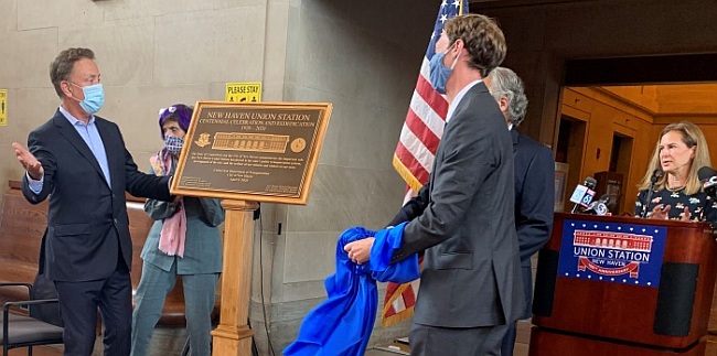 Governor Ned Lamont and Mayor Justin Elicker unveil a bronze plaque commemorating the centennial of Union Station in New Haven.