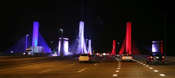 The Pearl Harbor Memorial Bridge in New Haven illuminated in red, white, and blue lights.