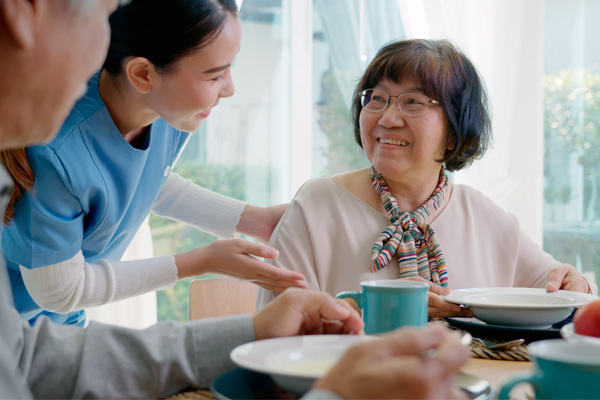 Senior woman smiles at nurse