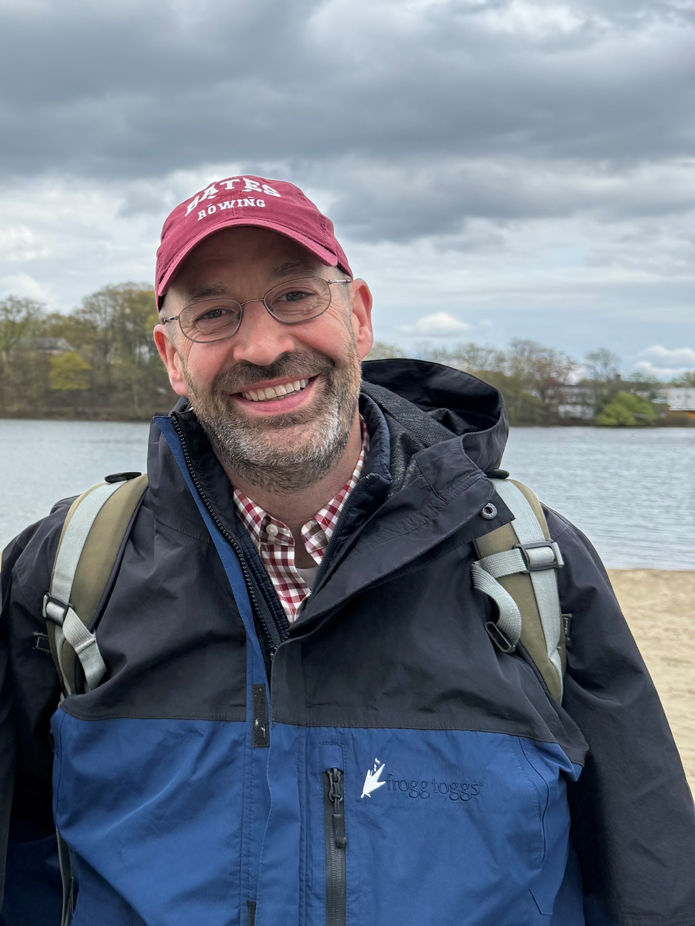 Headshot photo of Scott Williams, Ph.D. wearing a red hat and a raincoat.