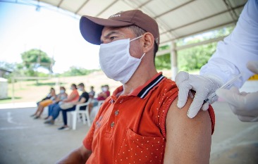 A man receiving a vaccine at a vaccine clinic.