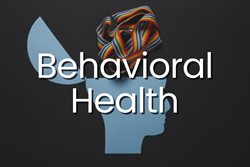 Cut paper side profile of a head with the top hinging open and a rainbow ribbon coming out is overlaid with text "behavioral health."