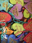 Image of paper hearts in different colors that all read "thank you"
