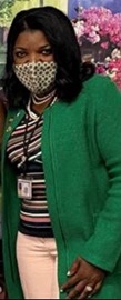 Photo of Commissioner Dorantes in a mask and green coat