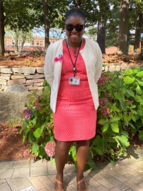 Photo of Commissioner Dorantes in a pink dress and sweater