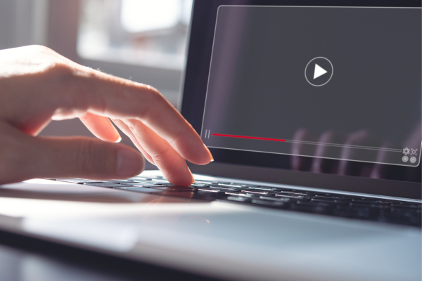 Individual watching a video on their computer