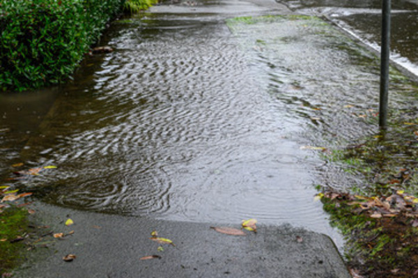 Aftermath of flooding on sidewalk