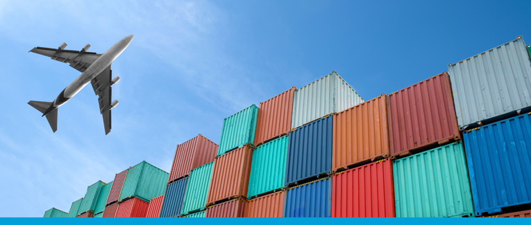 Airplane flying over shipping containers