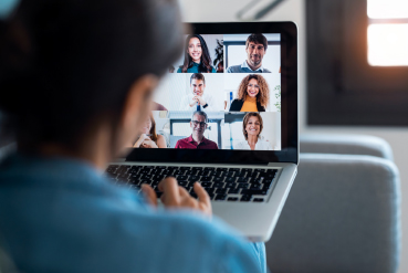 Person using laptop in virtual meeting