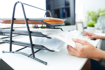 Person holding paper files