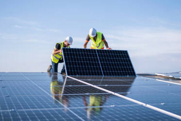 Workers installing solar panels