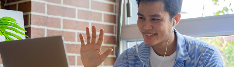 Get started image of man waving to computer screen