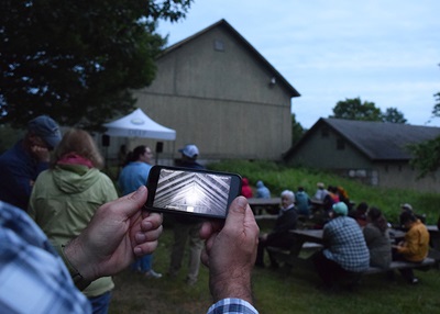 People watching bats emerge from a barn at White Memorial Conservation Center.
