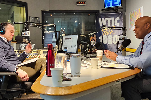 Commissioner Higgins sitting down with host at WTIC.