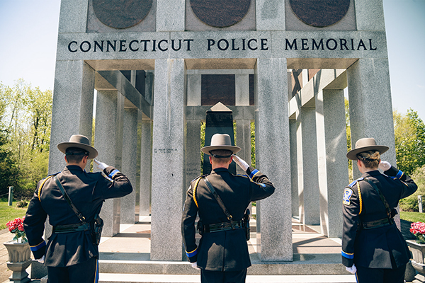 Three CSP officers saluting.