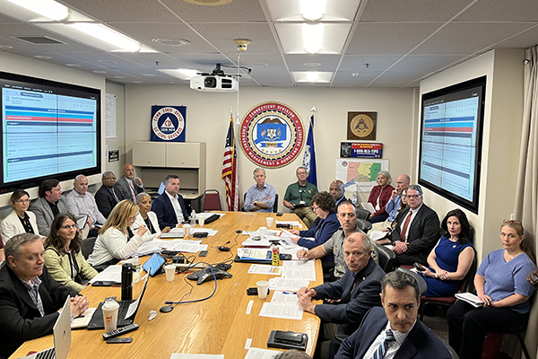 Division of emergency management team in a meeting with Commissioner Higgins.