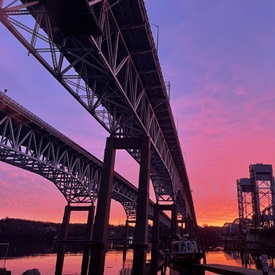 Image of the Gold Star Bridge taken from the ground at sunset