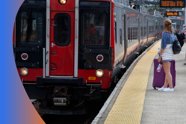 Woman with suitcase waiting to board a Connecticut train 