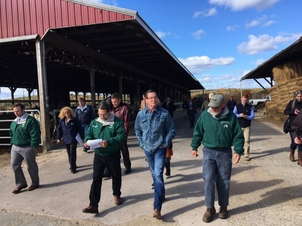 Ned Ellis (right), owner of Maple Leaf Farm in Hebron, takes Governor Malloy and Agriculture Commissioner Steven K. Reviczky on a walking tour of the 450-acre dairy farm and discuss the positive impact that the state’s Farmland Preservation Program has had in helping the economic success and growth of the business, which is a member of The Farmer’s Cow. (October 25, 2016)