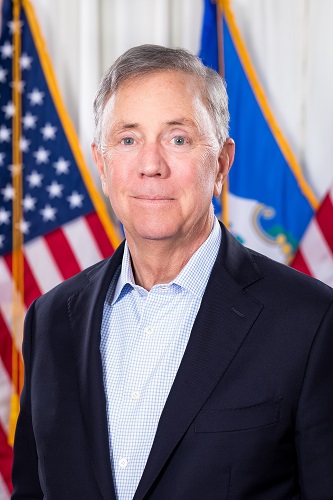 Headshot of Governor Lamont standing in front of a United States flag and a Connecticut flag
