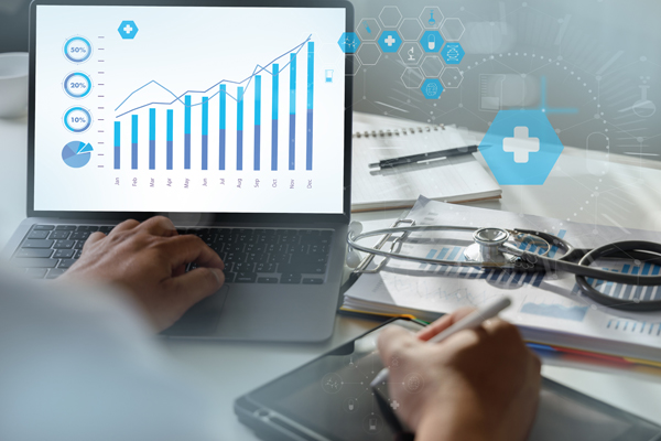 person with stethoscope on laptop